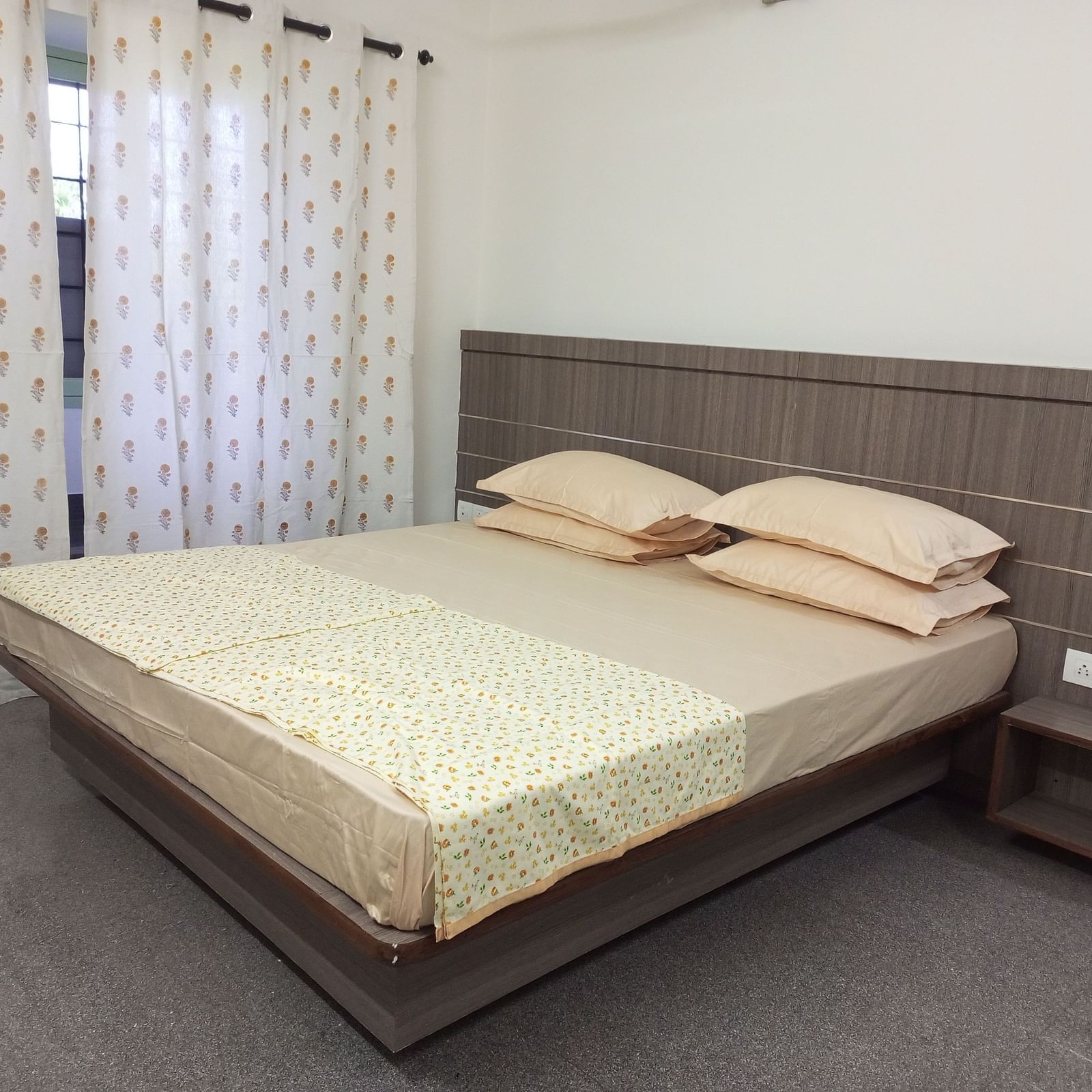 A spacious bedroom with a large window and natural light.
