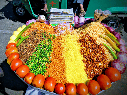 A stall of jhalmuri ,Kolkata 's famous puffed rice with fresh topping and spices on display.