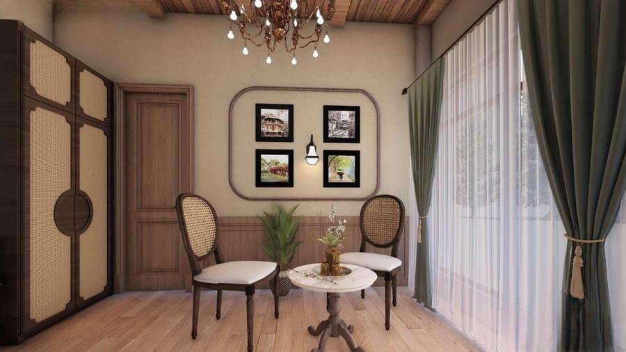 Small sitting area with circular wooden doors, a rounded picture frame, and elegant traditional chairs at BluSalzz Terrah Hills Resort, Dalhousie.