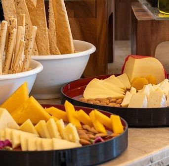 A close up shot of cheese platters placed on a table at Nirvana Luxury Hotel, Ludhiana.