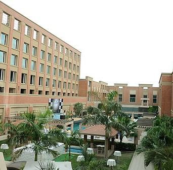 Facade view of Nirvana Luxury Hotel, Ludhiana with clear blue sky in the background.
