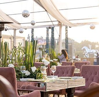 A dining venue in an open-air setting at Nirvana Luxury Hotel, Ludhiana.