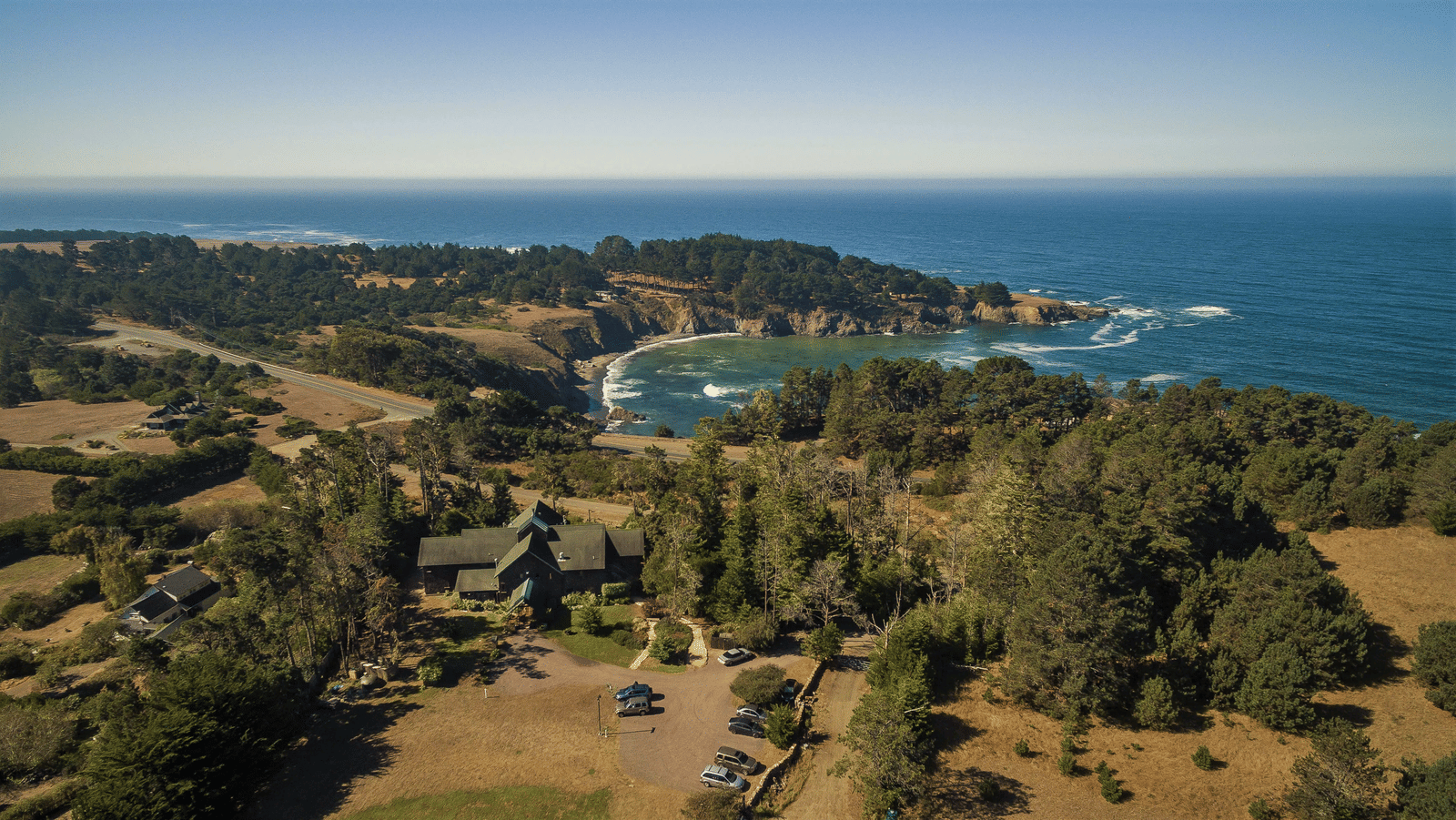 An aerial view of Brewery Gulch Inn featuring the vast ocean stretching to the horizon.
