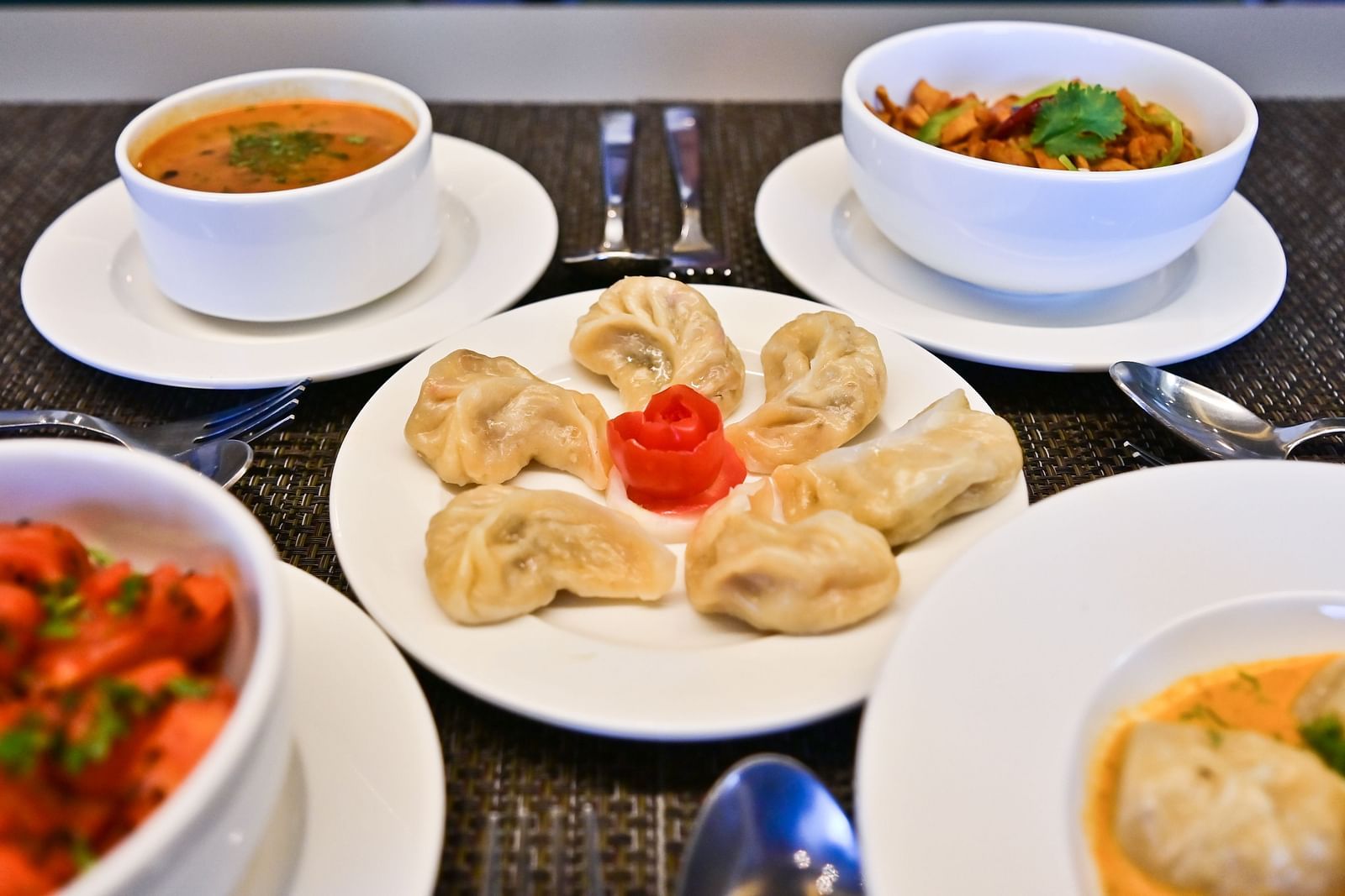 Front view of variety of dishes set on the tables at The Soma Hotel by Avianna Group, Darjeeling