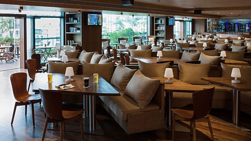 Indoor restaurant dining room with a contemporary, warm ambiance.