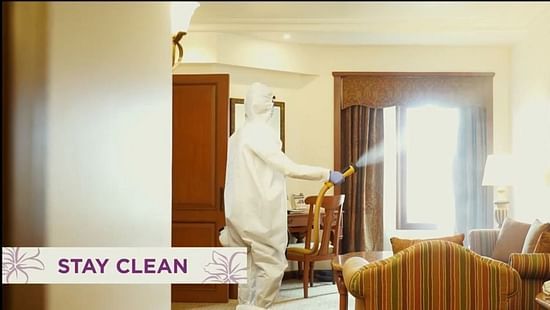 a person wearing a ppe kit and sanitizing a hotel in mumbai