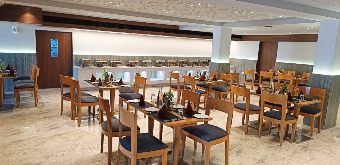 All-day dining restaurant at Lords Eco Inn Dahej offering a welcoming ambience with wooden décor.
