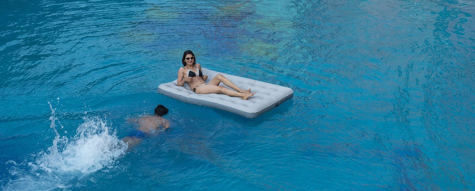 A lady lying on an inflatable in the pool at Nirvana Luxury Hotel, Ludhiana