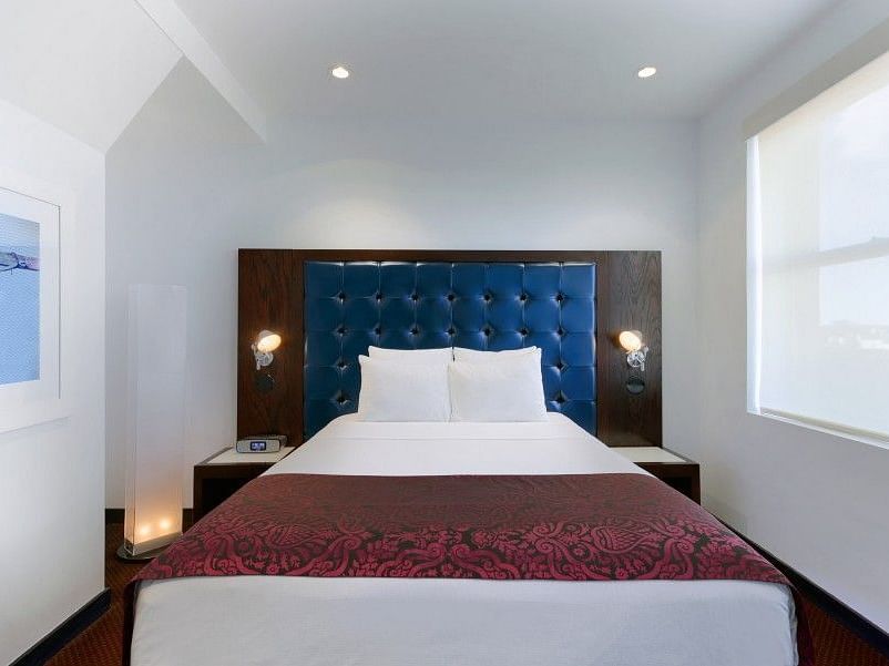 A large room with a bed and a window that overlooks the surroundings