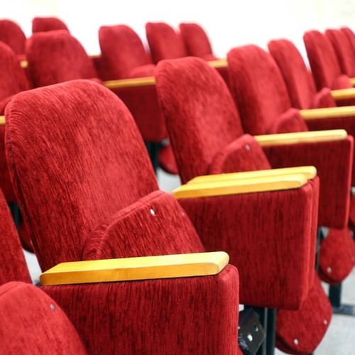Side view of the red colours chairs in the cinema hall