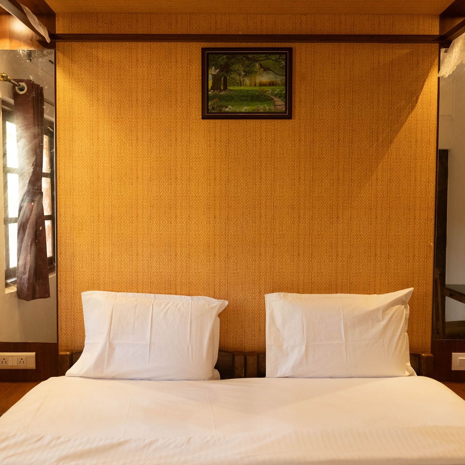 Image of a bed with wooden headboard at 2bhk Studio Apartment, Vistar Holidays, Goa.