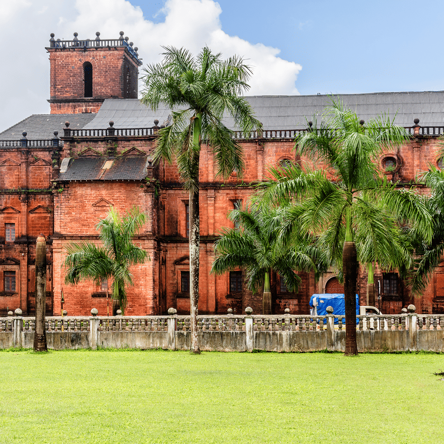 facade view of Basilica of Bom Jesus with trees and a manicured garden in front of it