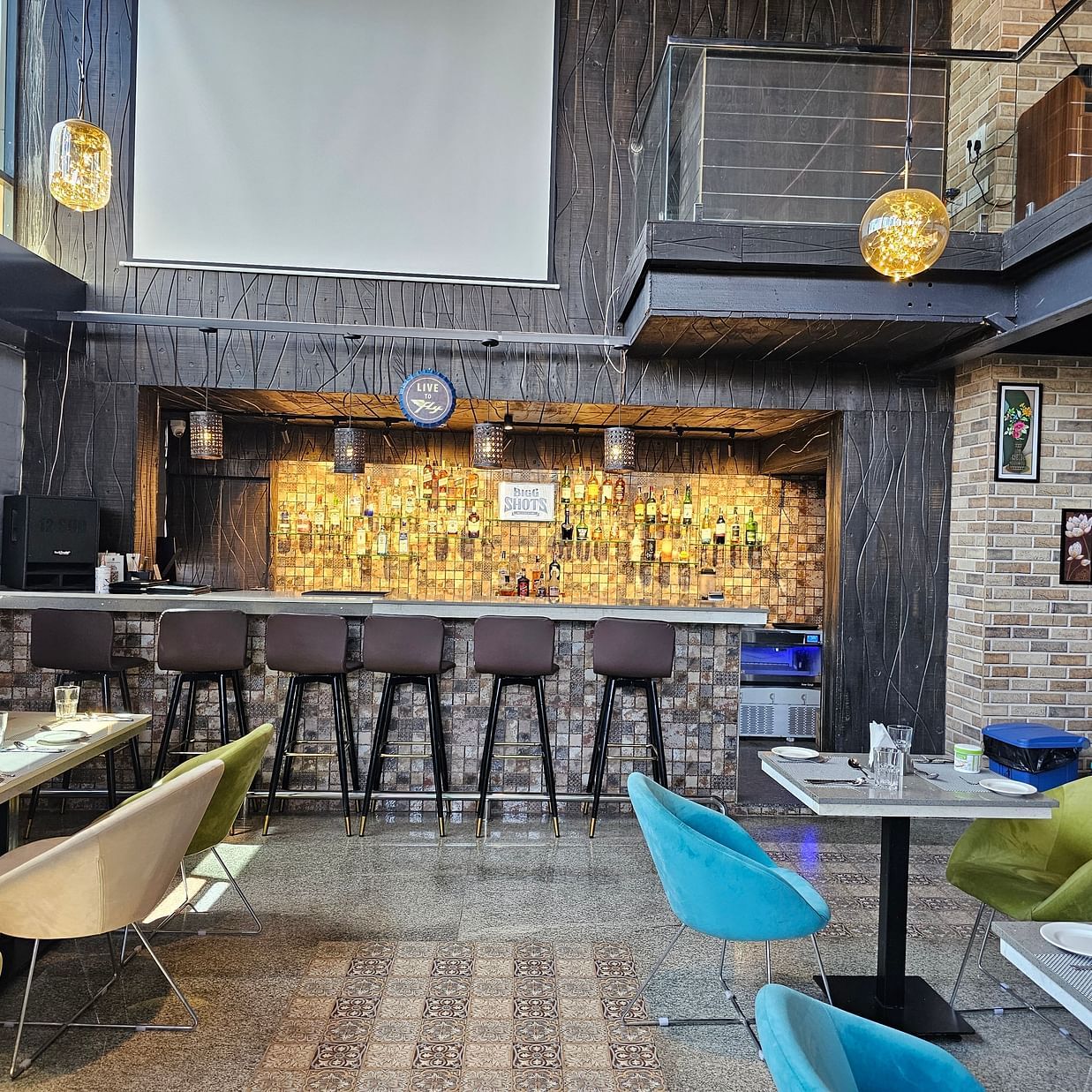 side view of the seating arrangements and a bar counter at Bigg Shots Resto Bar in Quality Inn Rockwell Grand