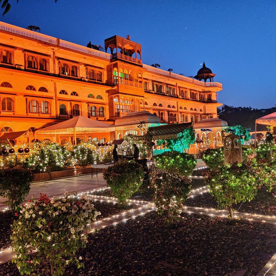 Night view of a grand traditional building with a well-lit lawn in the front yard - Umaid Palace - A Lakeside Heritage Palace Resort