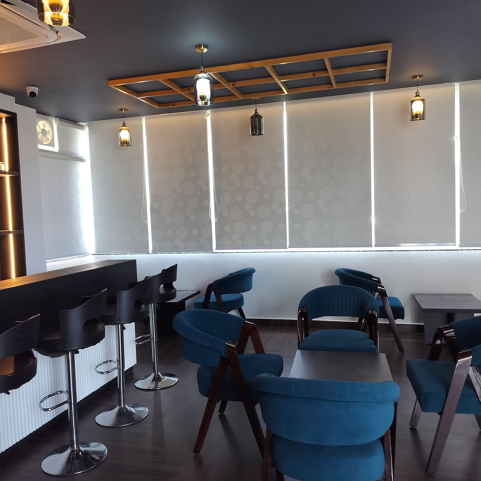 image of the forest ground cafe with blue coloured chairs - Eminence The Corbett
