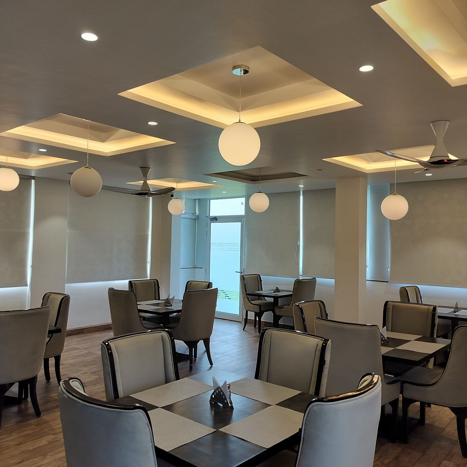 full view image of the dining area at panther's perch with window shades rolled down - Eminence The Corbett