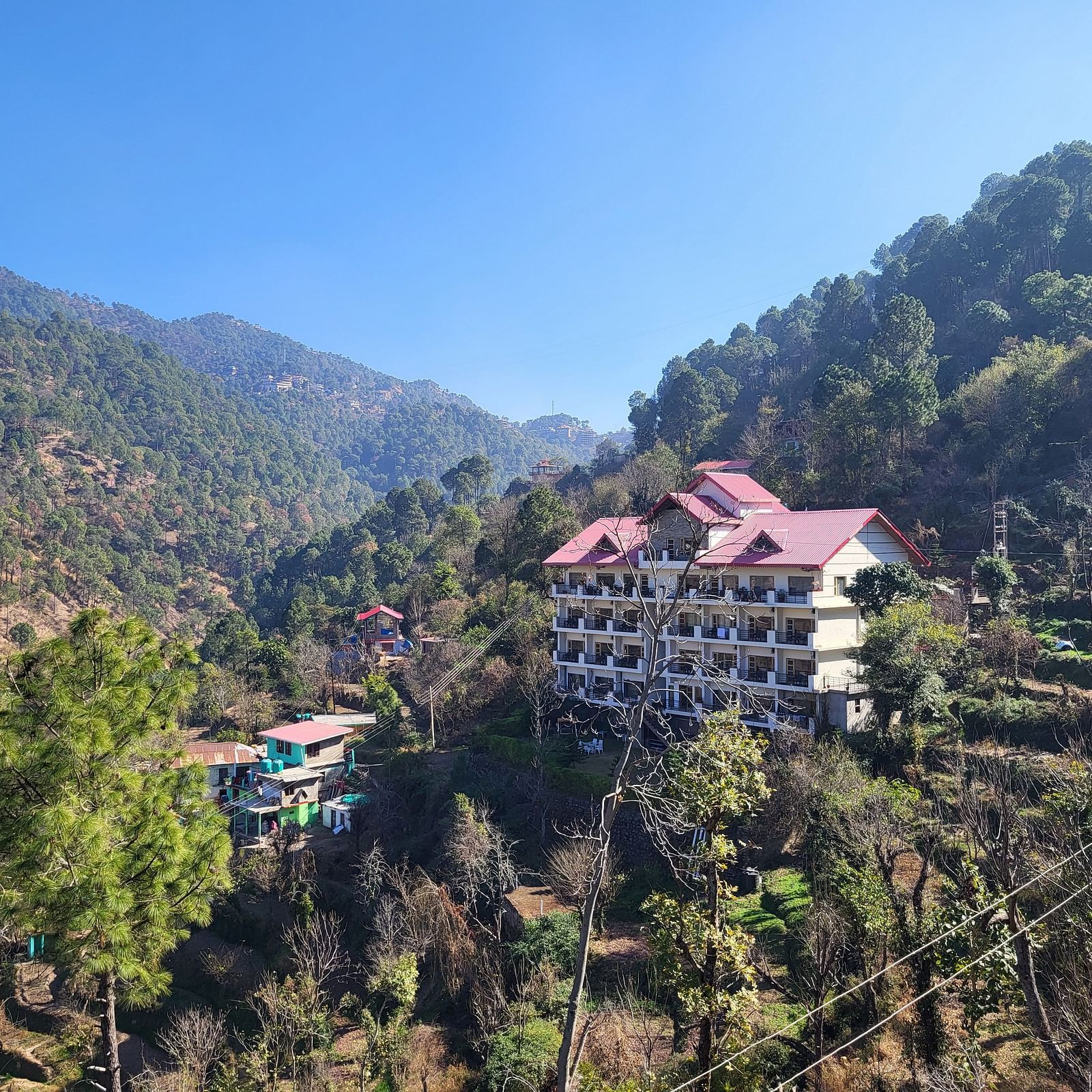 A breathtaking aerial view from Dagshai Manor Kasauli - Inde Hotels surrounded by lush greenery and mountain landscapes.