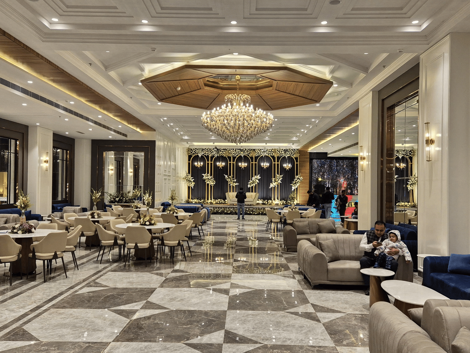 Spacious and modern banquet hall with plush seating and a central chandelier at Ramada by Wyndham Sonipat Murthal