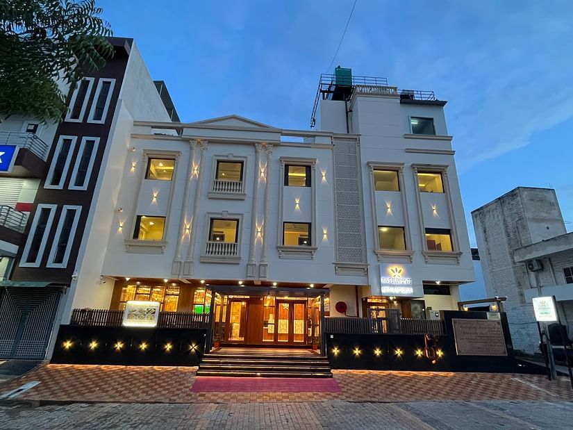 An image of a well lit facade of Five Elements Hotel, Jodhpur which also has buildings on either side