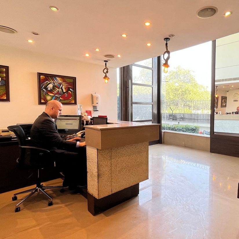 the reception desk at yuhi mansions shot from different angles showcasing a staff working while wearing a suite3