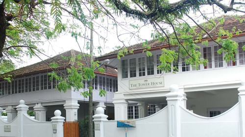 Exterior of The Tower House in Kochi, with elegant, white architecture.