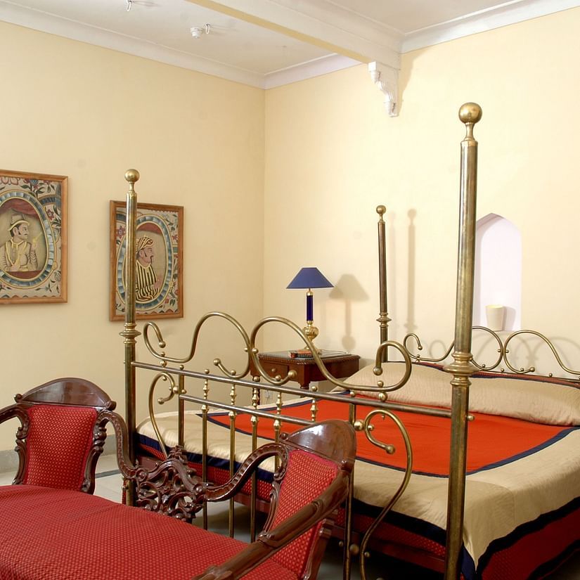 a bedroom with a large bed and a sofa for sitting - Hotel Castle Mandawa, Jhunjunu