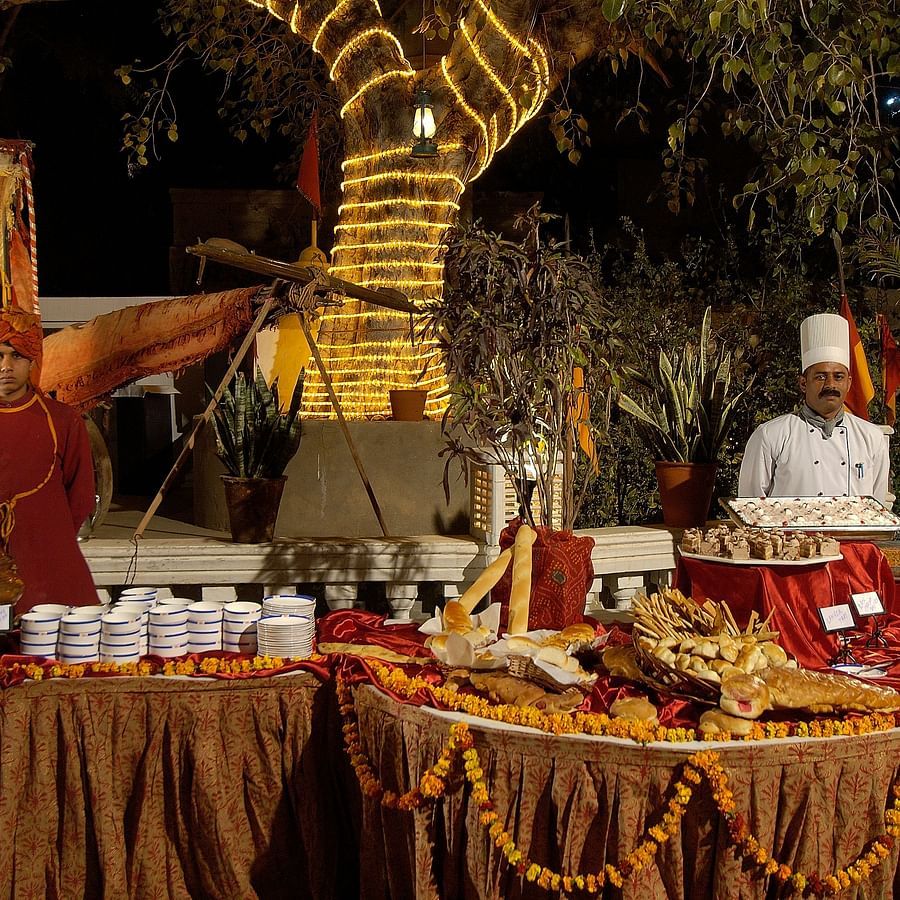 Gala Dinner at Gulab Bagh with people serving food  - Hotel Castle Mandawa, Jhunjunu