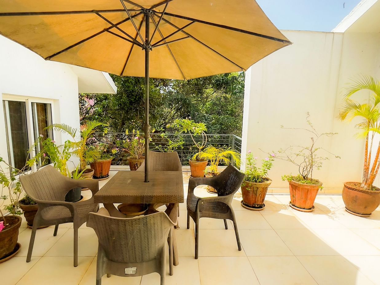 seating arrangements below a big unbrealla in the terrace of El Benito Goa