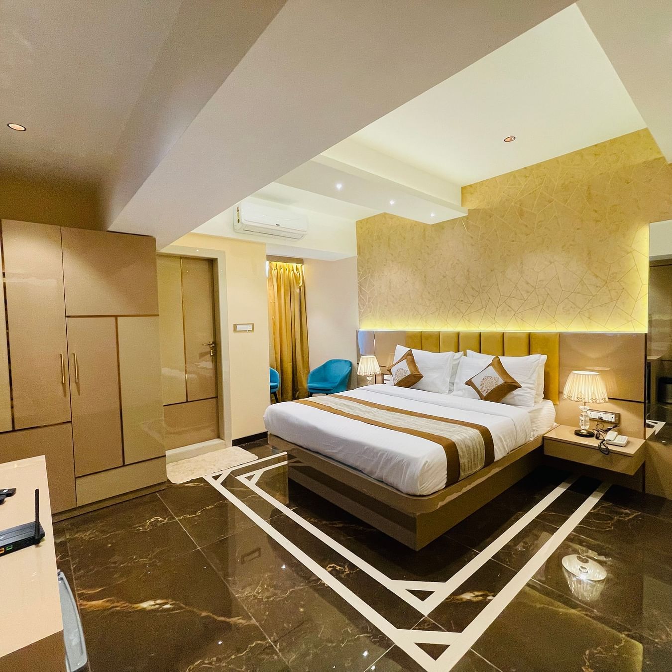 Side view of the king bed inside Deluxe Suite Room - Home2 Renaissance Club Hotel