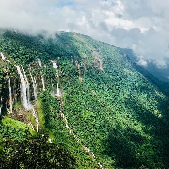 an overview of the mountains in Meghalaya with waterfalls cascading down