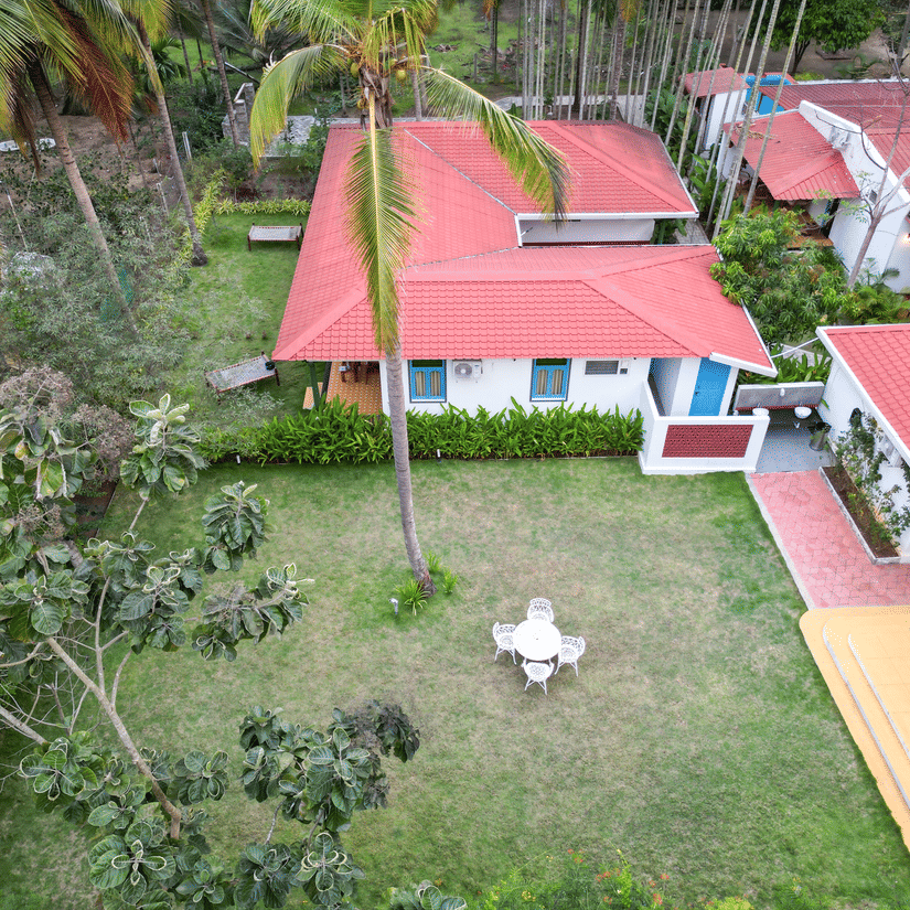 Aerial view of Ibex Resorts, Coimbatore (Kakarla), showcasing the resort's cottages, lush surroundings, and event spaces.
