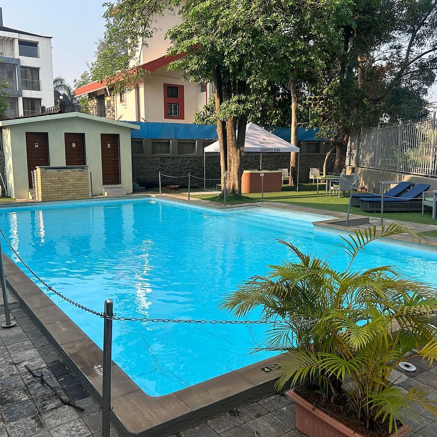 Sparkling outdoor swimming pool, surrounded by greenery and relaxing seating areas – Maxxvalue Klub Klass Villa, Lonavala.