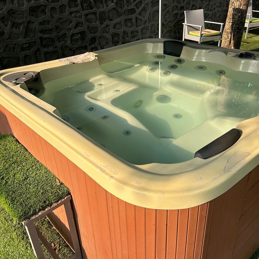 Outdoor jacuzzi with warm bubbling water, set in a peaceful garden space – Maxxvalue Klub Klass Villa, Lonavala.