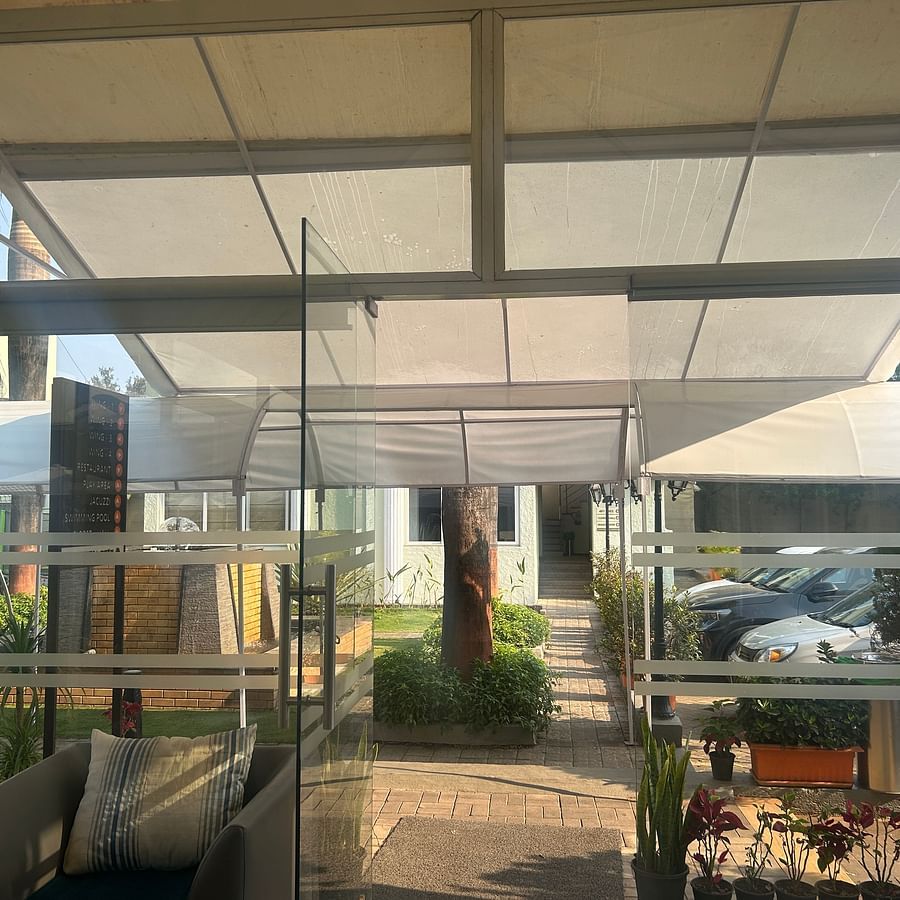 Glass-enclosed outdoor seating area – Maxxvalue Klub Klass Villa, Lonavala.