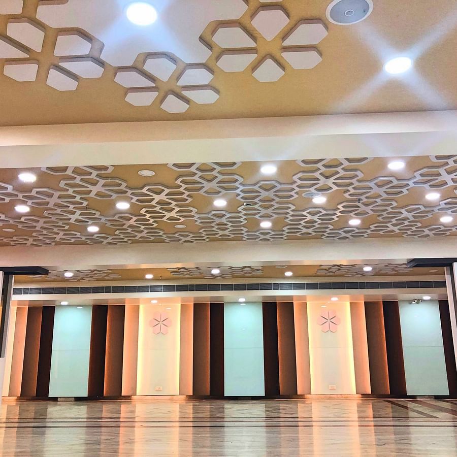 an empty Banquet Hall in Tirupati with many lights switched on - Raj Park Hotel, Tirupati