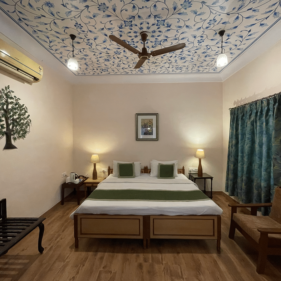 Double bed at Deluxe Double with pretty stickers on the walls and roofs at Suryaa Villa Jaipur