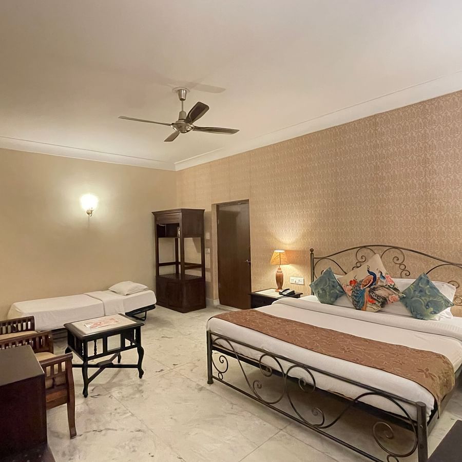 A double and a single bed in the Deluxe triple room at Suryaa Villa Jaipur
