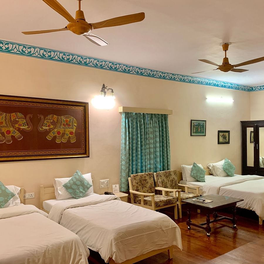 Two twin and one double bed at the family room at Suryaa Villa Jaipur