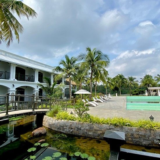 Pond with pool and resort facade in Background