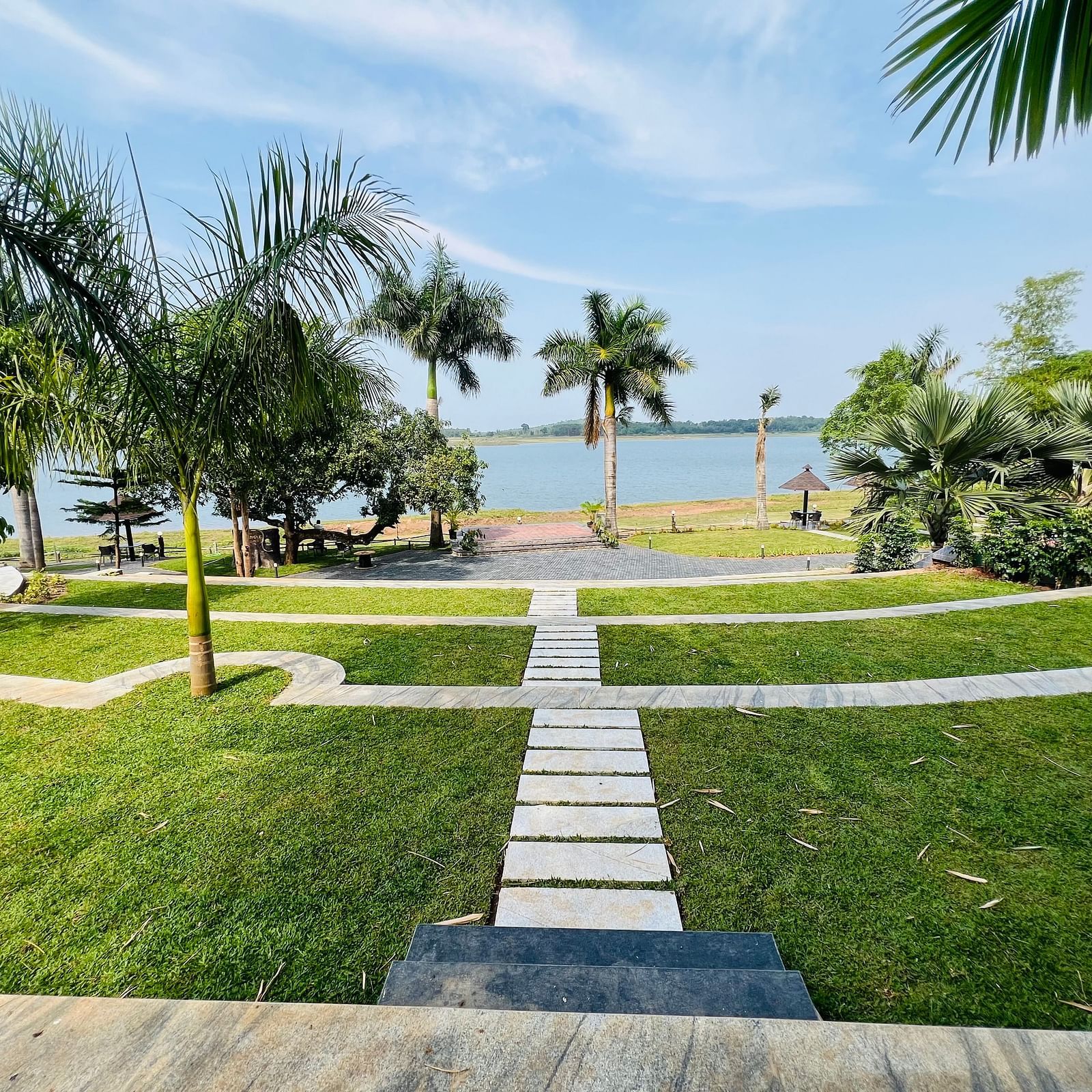 Lush gardens and open spaces facing the backwaters at Coorg Jungle Camp Resort, perfect for leisure and lakeside picnics.