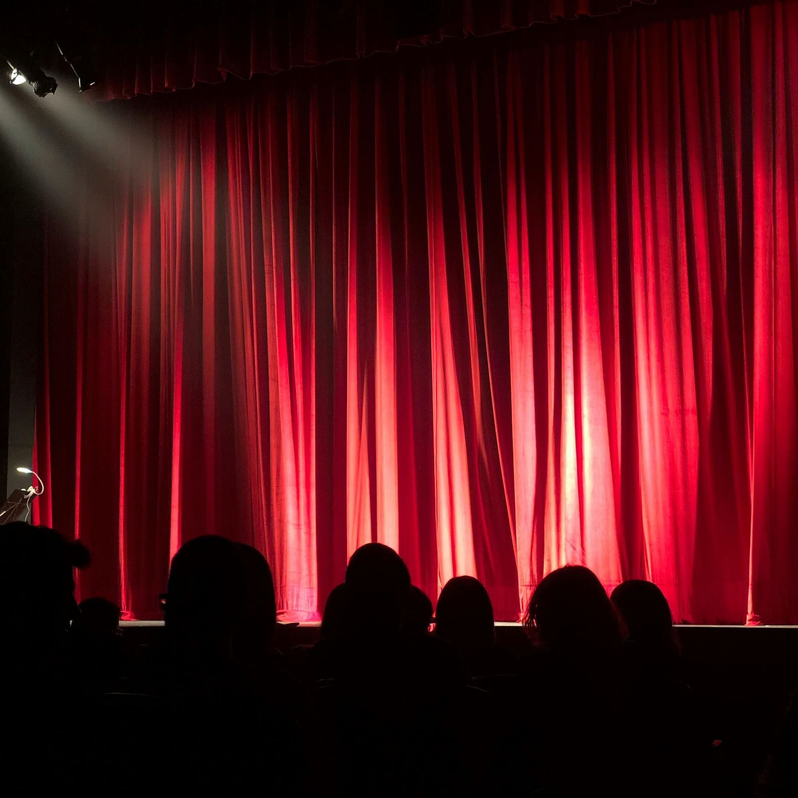 A view of a red curtains on a stage. 