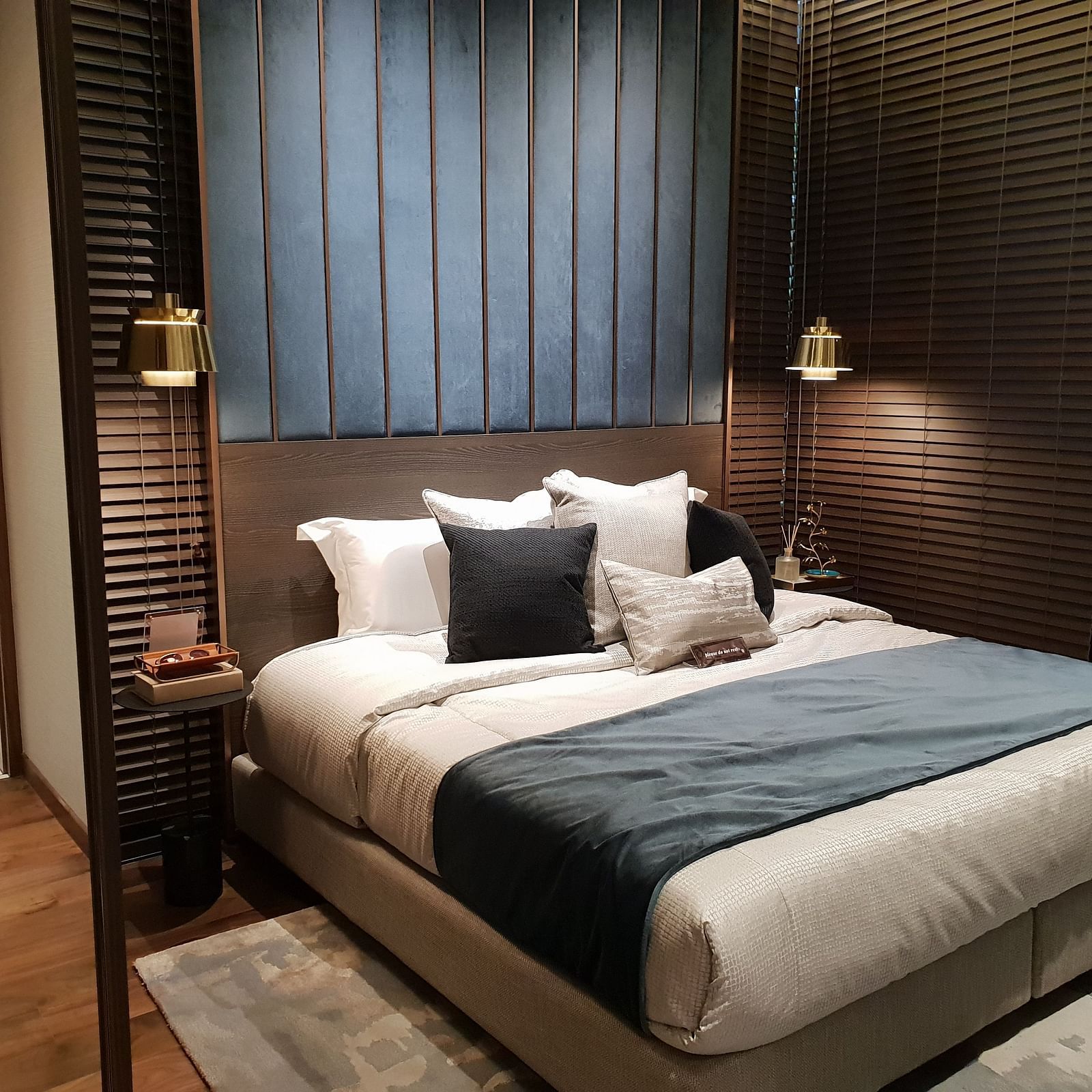 A double bed with lamps and side table on either side of it