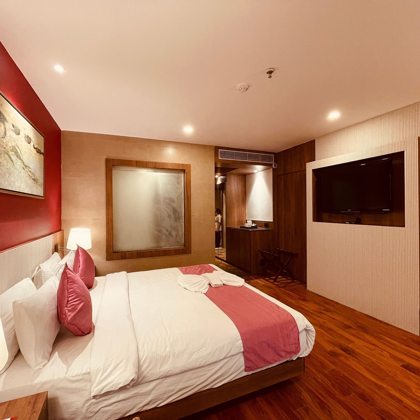 Corner view image of the Superior Room with a double bed featuring a huge translucent glass window - Senses Hotel