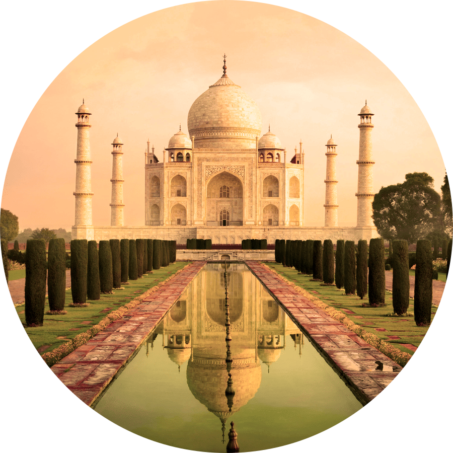 Taj Mahal, Agra featuring a pathway with trees on either side and a pool in between leading to the monument