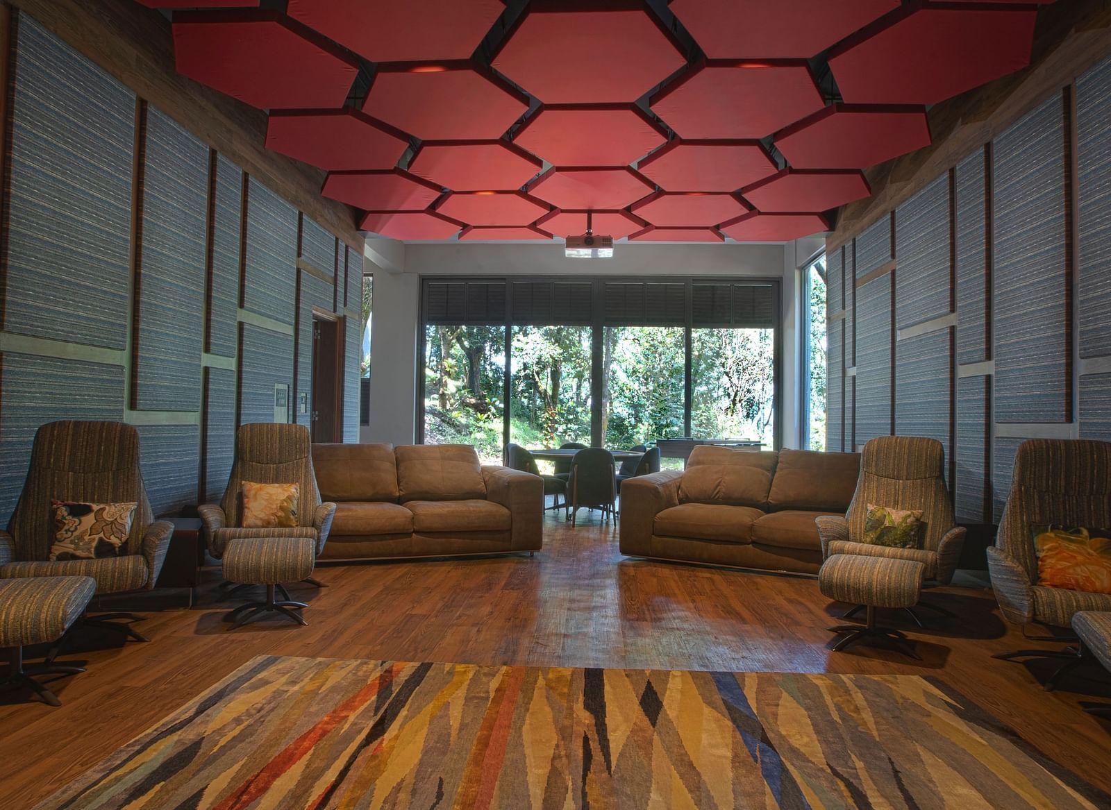 A movie theatre featuring plush sofas and single-seater chairs at Stanley Revelation.