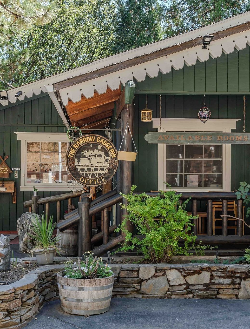 A view of a wooden cabin with a pastel green exterior