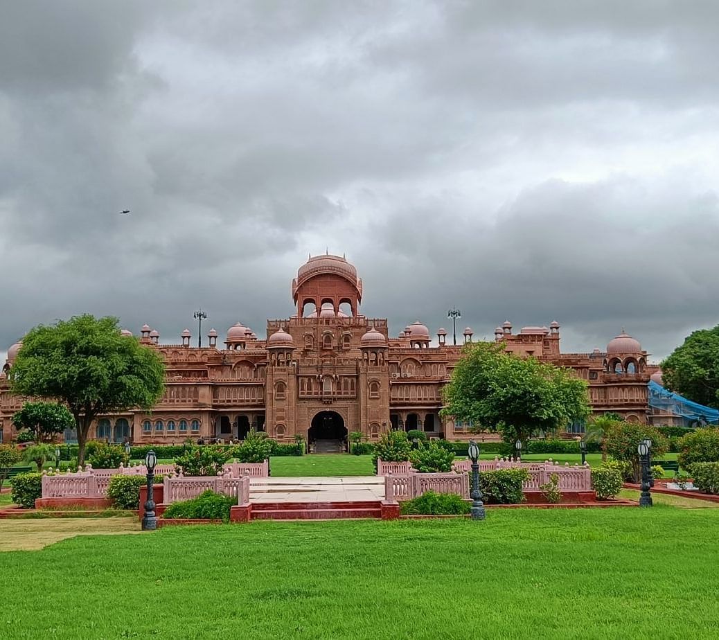 A facade image of The Laxmi Niwas Palace during a cloudy day