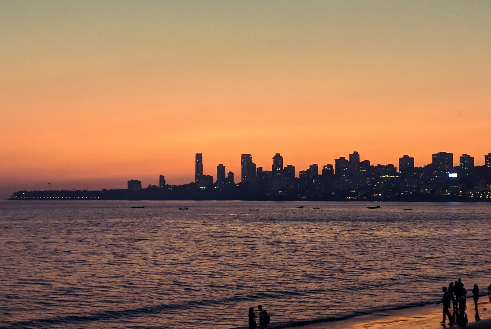 Shot of Marine drive overlooking the Arabian Sea during sunset with buildings in vicinity.