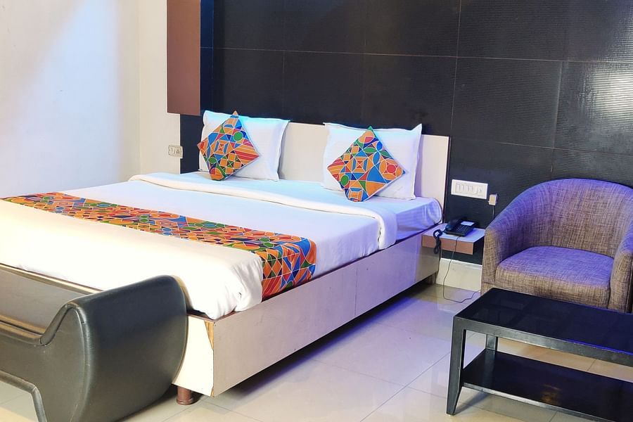 alt-text Deluxe Room: Stylish Deluxe Room at Udipi Home featuring contemporary decor and comfortable bedding