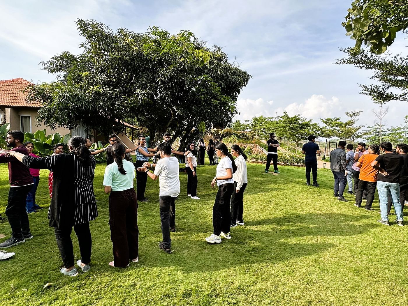 A group of people at Ravishing Retreat invested in group activities outdoor on a sunny day on the lawn